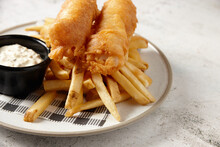 Close Up Shot Of Fish And Chips With Buttermilk Ranch Dipping Sauce All Placed In  A White Plate