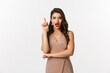 Christmas, holidays and celebration concept. Excited young woman with red lipstick, party dress, having an idea, raising finger in eureka gesture, suggesting something, white background