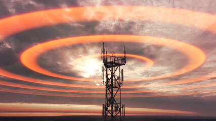 Wireless telecom radiation with aerial footage. Silhouette of telecommunication tower construction with antenna dishes on red sunset. Mobile digital radio waves animation from the high cellular mast.