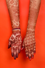 Wall Mural - Beautiful henna or mehendi decoration on a hindu bride's hand & Feet | Isolated hand & feet with diya
Red & Yellow Background