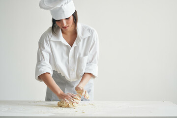 Wall Mural - woman chef roll out the dough bakery cooking