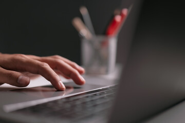 Man using laptop computer working for new idea at desk in the office late at night with copy space