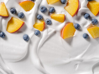 Yogurt with peach and blueberry, background. Flat lay, top view. Concept for packaging design.