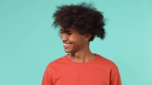 Overjoyed Vivid Young Curly African American Man 20s Wears Azure T-shirt Looking Camera Shaking Head Have Fun Enjoy Play Fluttering Hair Isolated On Plain Pastel Light Blue Background Studio Portrait