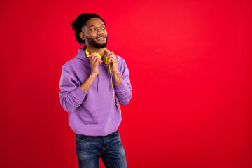 Wall Mural - Photo portrait man with dreadlocks wearing headphones looking copyspace isolated vibrant red color background