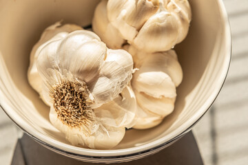 Poster - Closeup of bulbs of garlic in a bowl