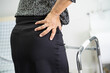© amazing studio - Asian lady patient pain her back wrist orthopedic lumbar with walker.