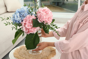 Canvas Print - Woman with bouquet of beautiful hortensia flowers in living room, closeup