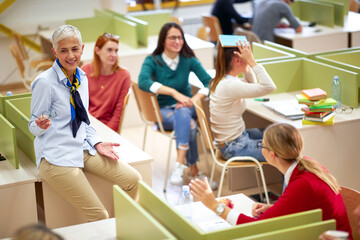 Wall Mural - Female professor and students having good time at the lecture