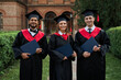 © Тарас Нагирняк - Portrait of three international students female and male with diplomas celebrating graduation in university campus