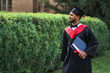 © Тарас Нагирняк - Handsome indian student celebrating graduation in university campus with diploma in robe