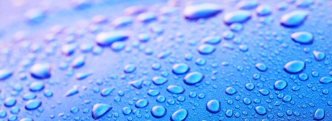 Bright blue background, crystal clear water drops (raindrops). Abstract natural pattern, wallpaper, concept art. Pink and purple gradient. Graphic resources, design, 3D, macro photography, decoration