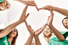 Group Of Young Volunteers Woman Smiling Happy Make Heart Symbol With Hands Together At Charity Center.