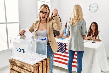 Poster - Group of young girls voting at democracy referendum angry and mad raising fist frustrated and furious while shouting with anger. rage and aggressive concept.