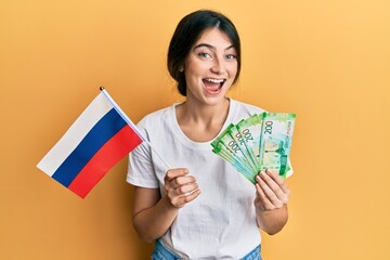 Wall Mural - Young caucasian woman holding pills smiling and laughing hard out loud because funny crazy joke.