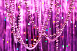 Fototapeta Dmuchawce - Pink Christmas bead garland hanging on a festive glitter background