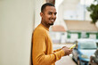 © Krakenimages.com - Young african american man smiling happy using smartphone at the city.
