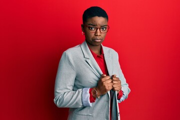 Sticker - Young african american woman wearing business jacket and glasses depressed and worry for distress, crying angry and afraid. sad expression.