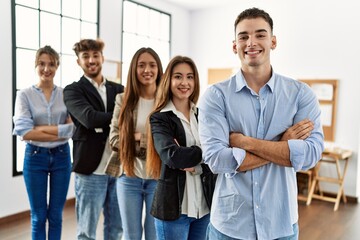 Group of young business workers smiling happy standing with arms crossed gesture at the office.