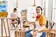 © Krakenimages.com - Young artist woman painting on canvas at art studio winking looking at the camera with sexy expression, cheerful and happy face.