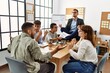 © Krakenimages.com - Businessman enjoys meditating during meeting. Sitting on desk near arguing partners at the office.