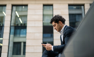 A financier makes a call to a colleague on a mobile phone. A bank employee near the office. A banker goes to work in a business suit. The lawyer responds to clients ' messages by phone.