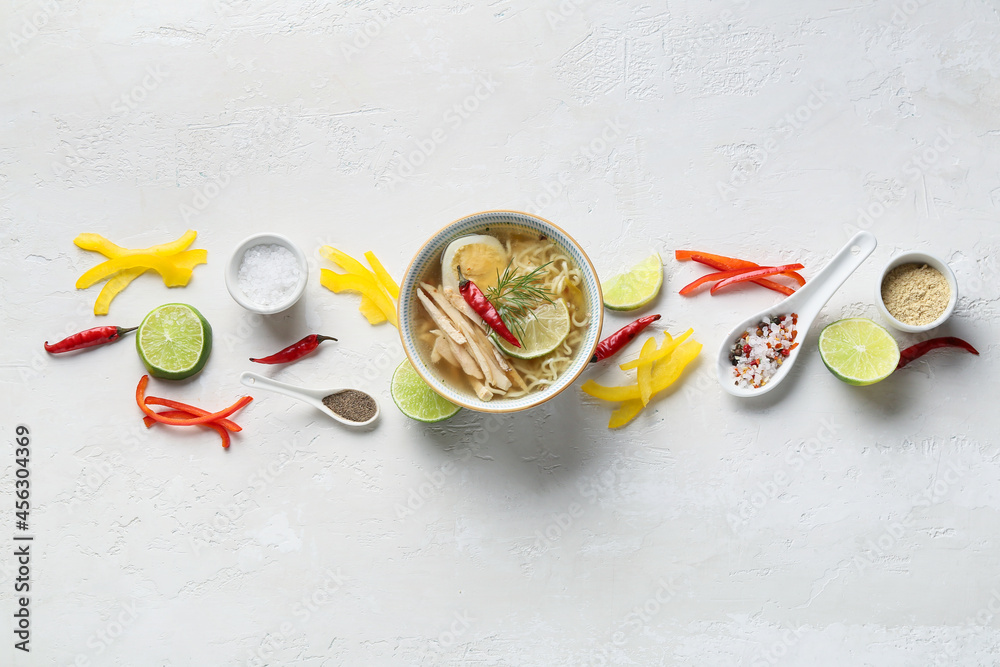 Composition with tasty Thai soup on light background