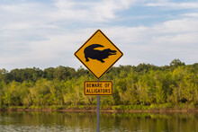 Beware Of Alligators Warning Sign On The Background Of A Beautiful Lake In Louisiana, USA