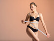 © Valua Vitaly - Young woman with tape and a beautiful, healthy body. Sexy woman measuring her perfect body.