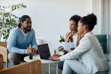 African American candidate talks to members of human resource team while having job interview in the office.