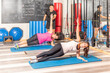 People doing lateral plank exercise in gym