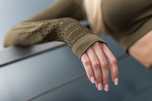 Close-up of female hand with pink manicure in sportswear