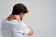 © SHOTPRIME STUDIO - man in a white t-shirt stress medicine pain in the neck isolated background
