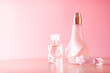 Luxury set of organic perfumes on pink background.