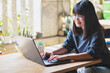 © stockphoto mania - asian teenager working on computer laptop in living room