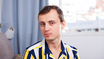 Portrait of young man in home interior