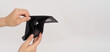 © nisara - Hand is holding and open black empty wallet isolated on white background..