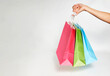 © Gecko Studio - Woman hand with shopping bags on white background