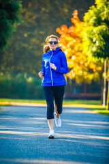 Wall Mural - Healthy lifestyle - woman running in city park
