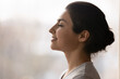 © fizkes - Meditation. Side profile shot of happy serene young indian female face. Calm millennial ethnic lady breath deep with closed eyes meditate feel zen good harmony peace of mind practice yoga meet new day