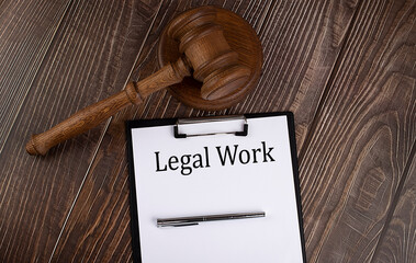 Poster - LEGAL WORK text on paper with gavel on the wooden background