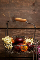 Fotomurales - Wire basket with autumn fruits and dried flowers. Seasonal home decoration.