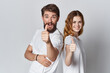 © SHOTPRIME STUDIO - cheerful young couple in white t-shirts emotions studio advertising design