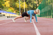 © splitov27 - Young athletic woman practices rock climber exercise at the stadium.