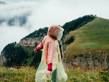 Woman In A Raincoat In The Mountains Nature Clouds Travel