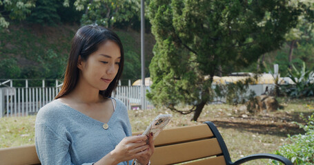 Wall Mural - Woman use of mobile phone at park