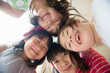 © Image Source Limited - Girls in huddle looking at camera, smiling