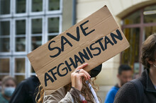 Female Activist Holding A Cardboard Sign With Text Safe Afghanistan At A Demonstration In Lubeck, Germany After The Taliban Takeover