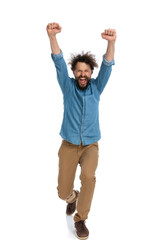 Poster - casual man walking towards the camera and celebrating the victory