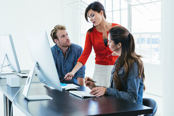 Business people working on computer by office window